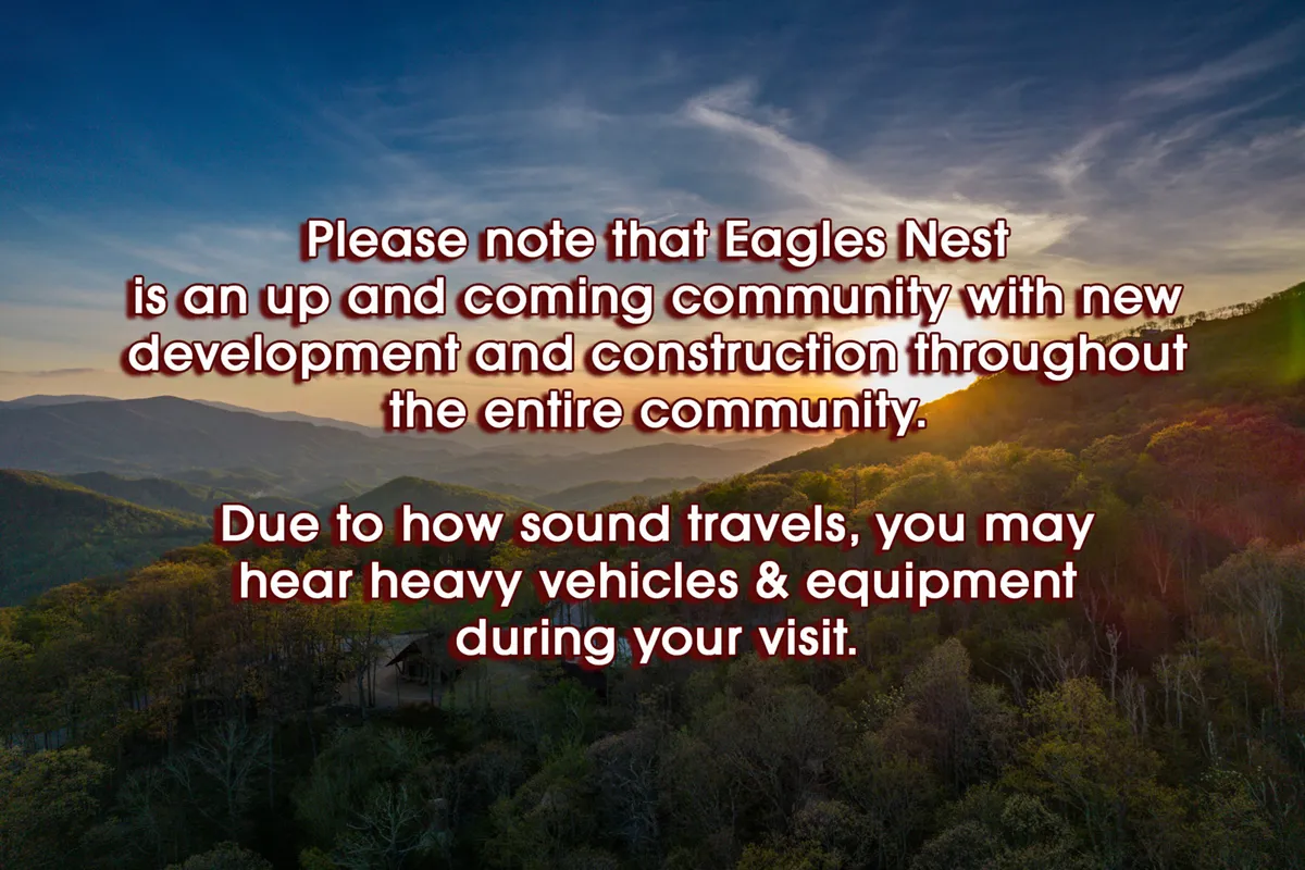 A sweeping view of the mountain range at sunset, with green hills in the foreground and a vibrant sky. The expansive landscape invites exploration and contemplation, reflecting the awe-inspiring natural beauty of Eagles Nest.